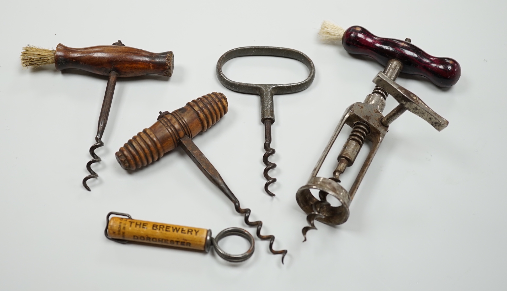 A 19th century iron corkscrew, with a turned wood handle and four other corkscrews (5)